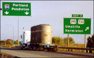 A WIPP truck with three TRUPACT-II shipping containers on back travels through the state of Oregon.