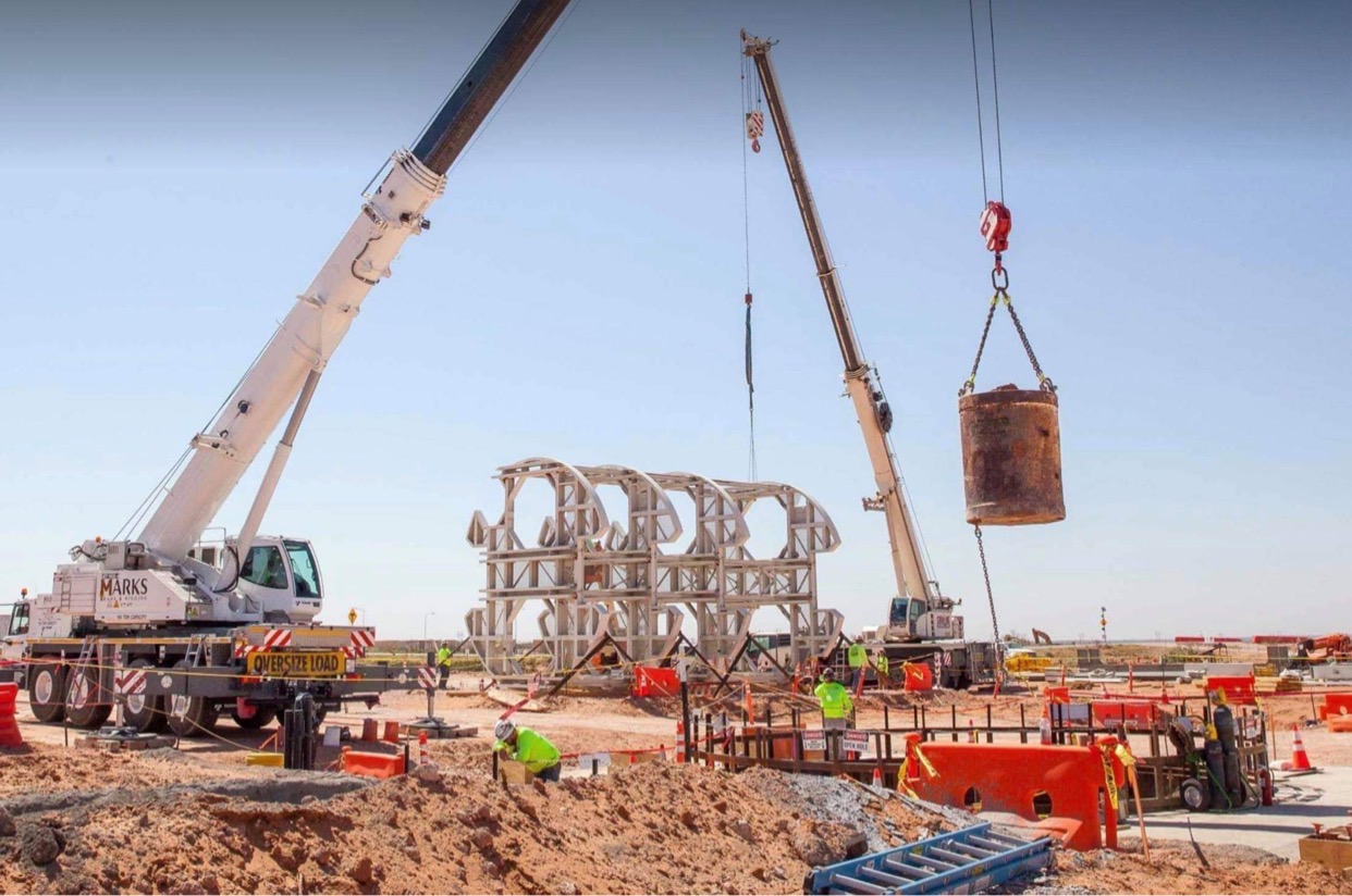 A bucket of excavated dirt is lifted out of the utility shaft that is being excavated at the Waste Isolation Pilot Plant