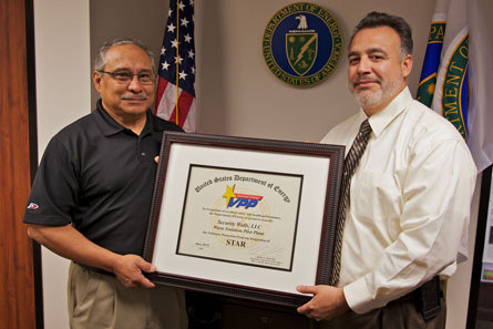 U.S. Department of Energy Carlsbad Field Office Manager Joe Franco (right) presents the Star of Excellence Award to Security Walls, LLC Manager Richard De Los Santos.